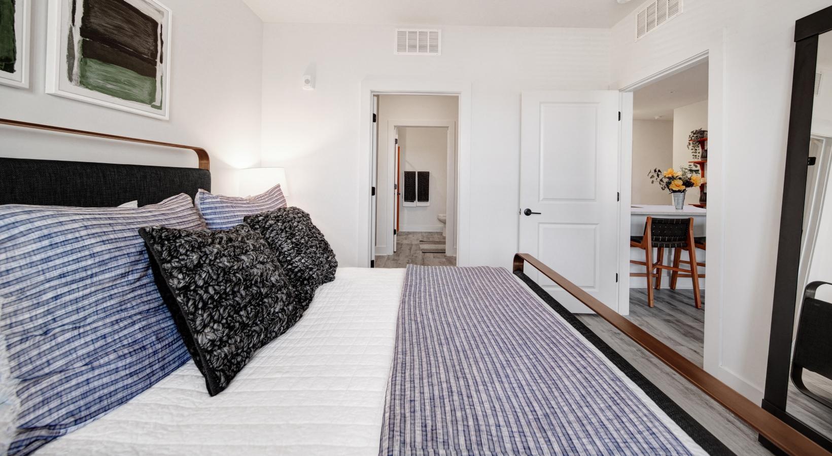 Generous bedroom offerings to fit every family a bedroom with a bed and a table