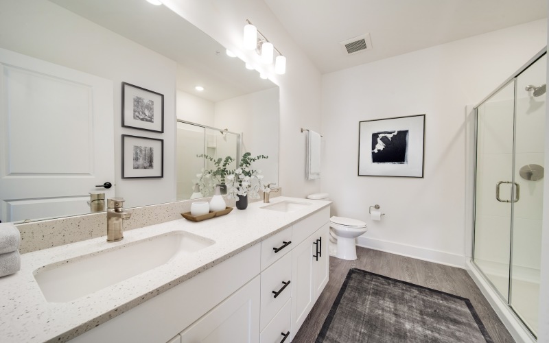 Bathroom with a large mirror and walk-in shower