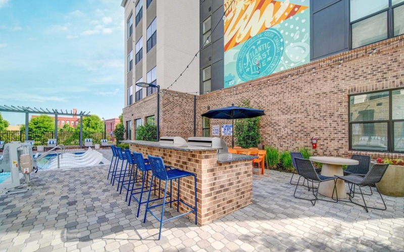 a patio with tables and chairs outside a building