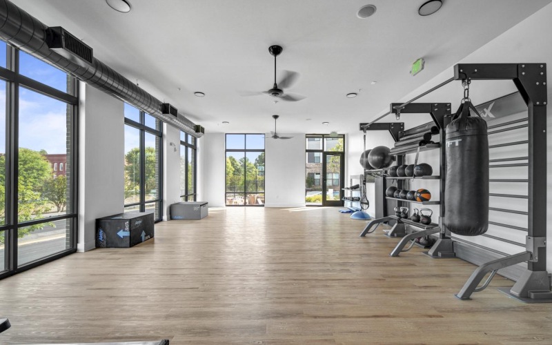 a room with a wood floor and large windows