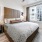 a bedroom with a bed and a plant