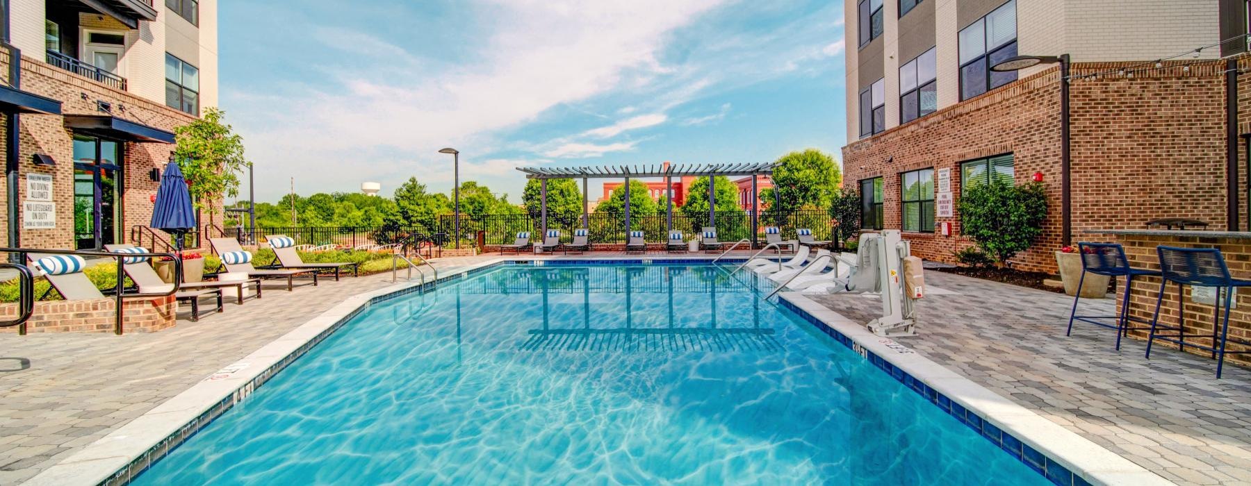 a swimming pool in a courtyard between buildings