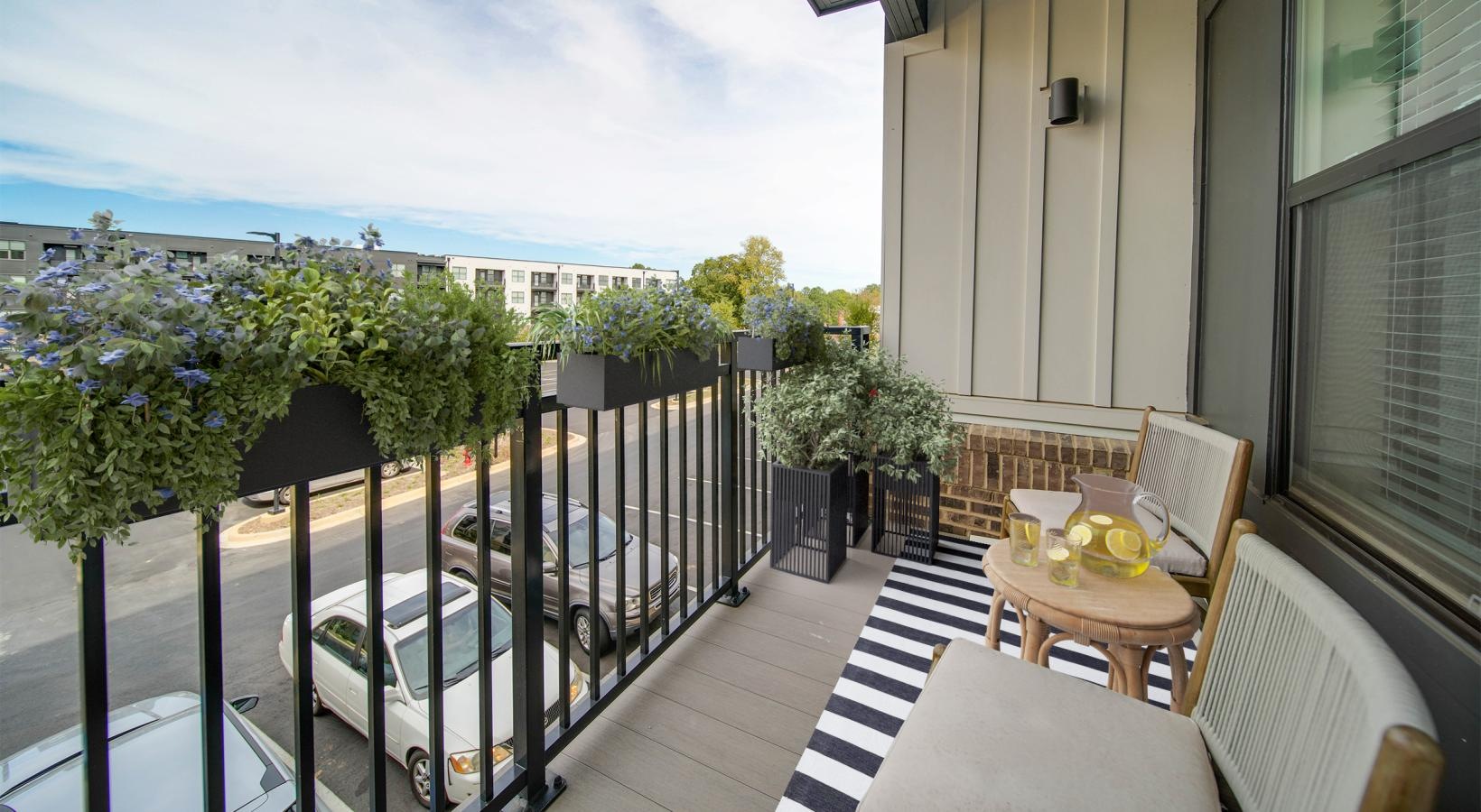 Private balconies in majority of units a balcony with a table and chairs
